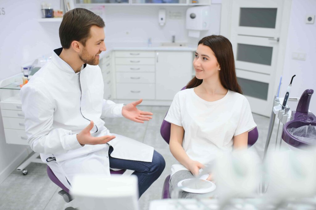 Dental patient talking to a dentist during their first visit