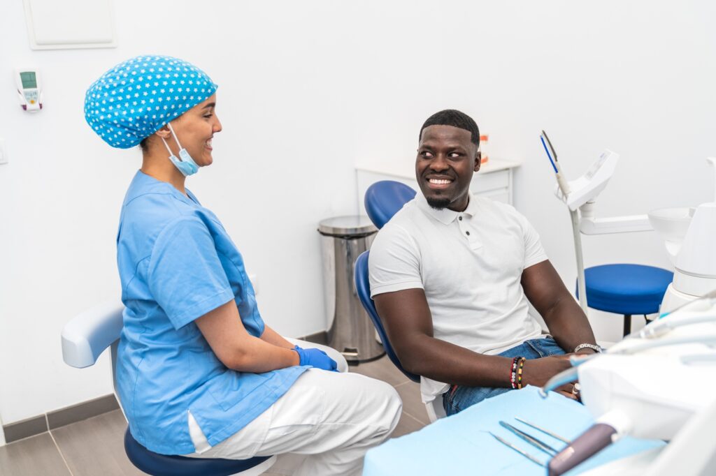 Dental hygienist speaking with patient during a consultation at a dental clinic