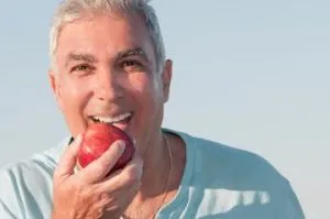 A man eats with ease after treatment from temporomandibular joint dysfunction specialists.