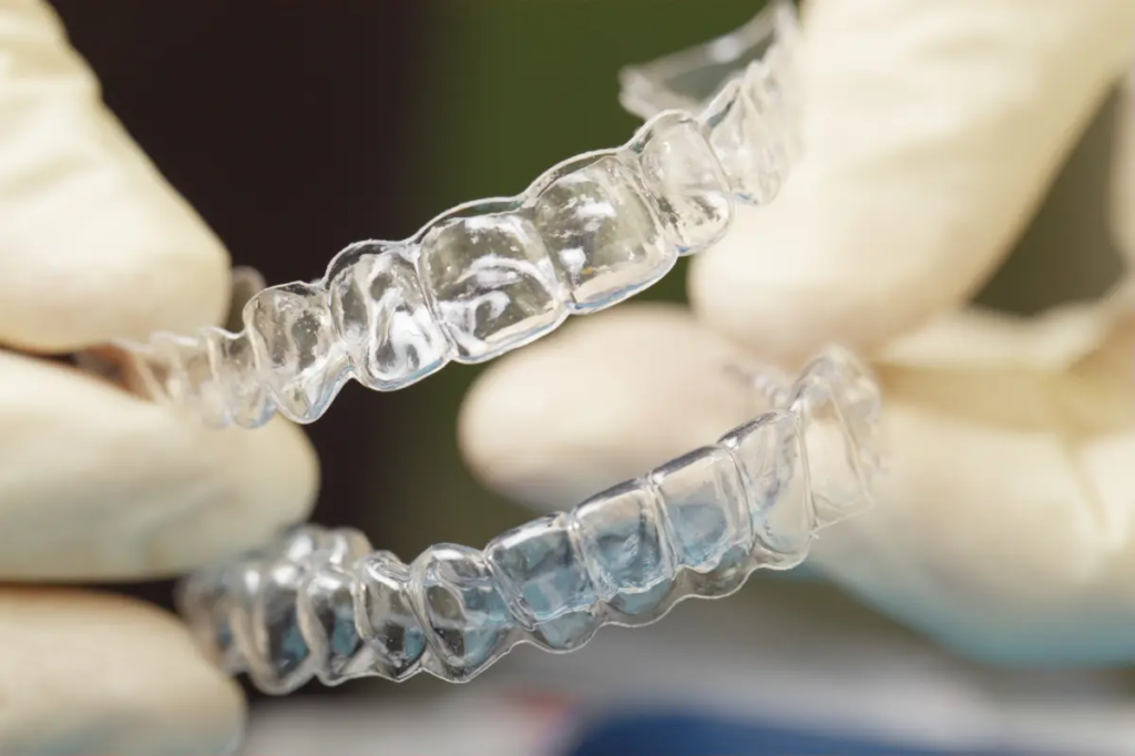 Closeup of clear dental aligners in hands