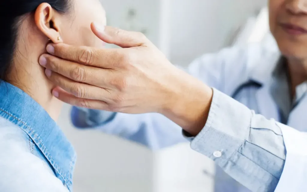 A temporomandibular joint dysfunction specialist evaluate's a patient's jaw for treatment.