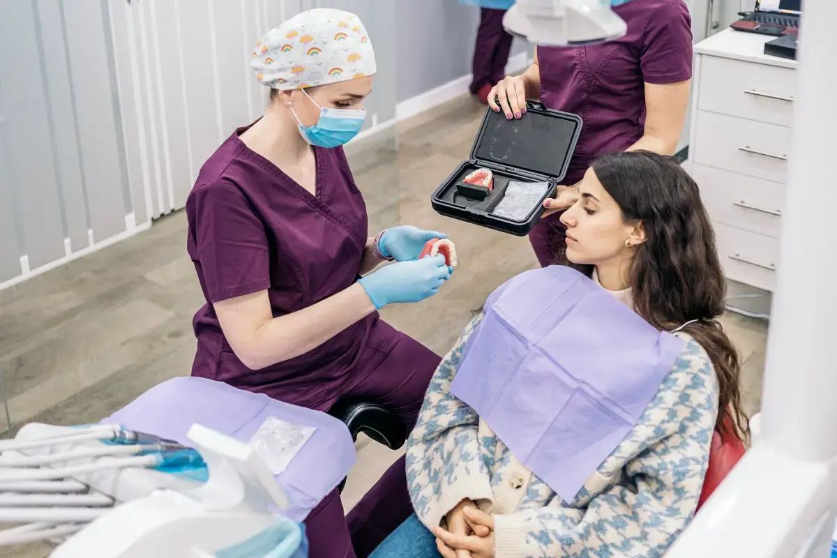 Dentist examining patient's teeth molds.