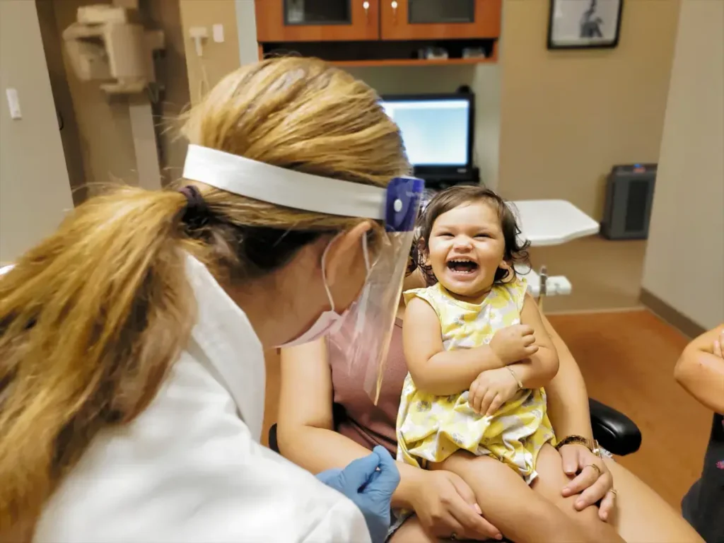 Happy toddler at dentist's office, smiling.